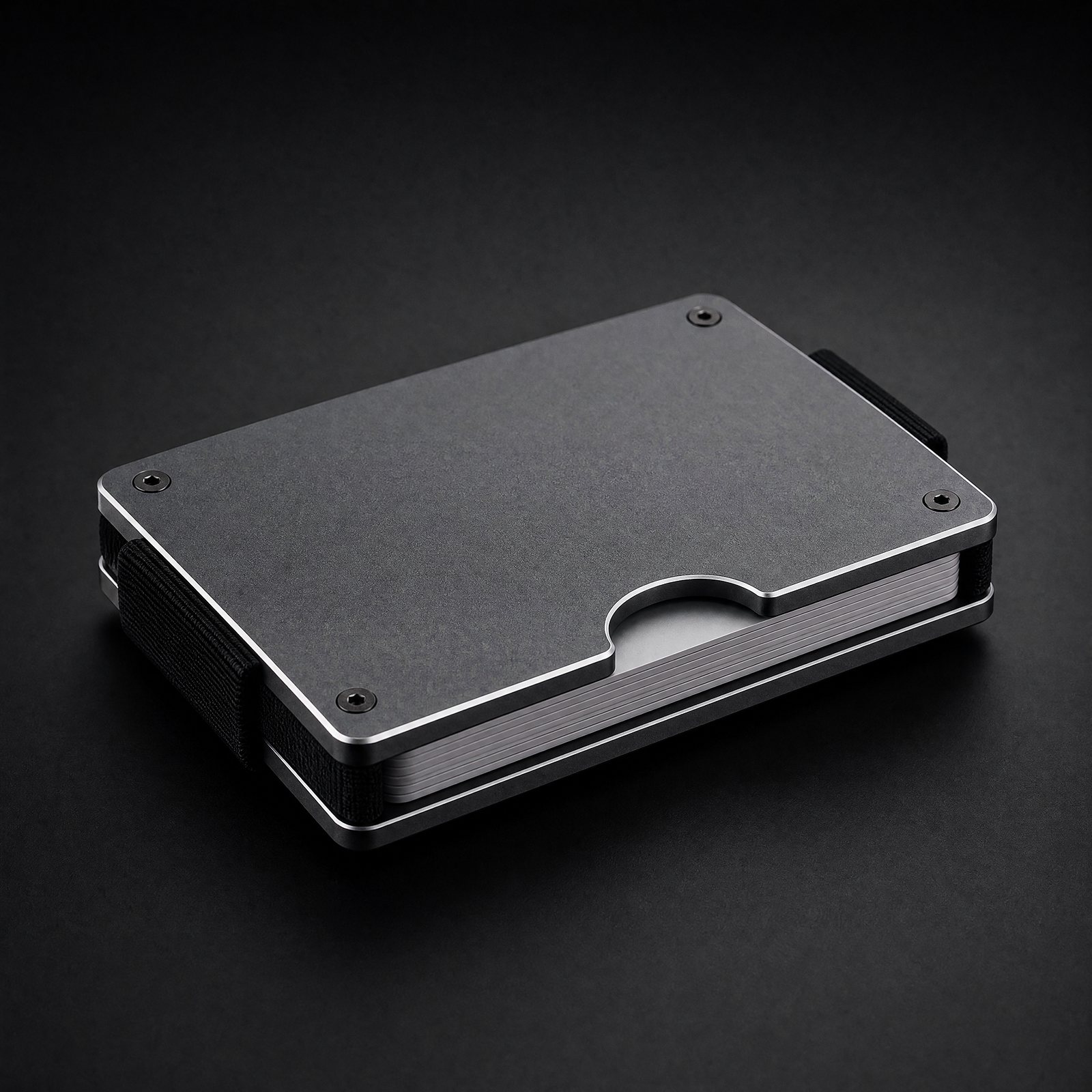ANODE Aluminum Wallet in graphite, three quarter view with cards between the plates